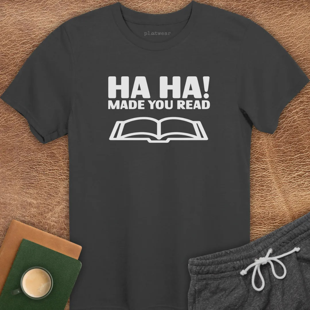 Maroon t-shirt with the text 'HA HA! MADE YOU READ' printed in white, accompanied by an image of an open book.