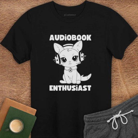 Black crew neck t-shirt with text 'AUDIOPBOOK ENTHUSIAST' and an illustration of a cat wearing headphones.