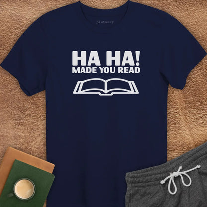 Maroon t-shirt with the text 'HA HA! MADE YOU READ' printed in white, accompanied by an image of an open book.