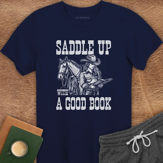 A navy blue crew neck t-shirt with a graphic print of a person on a horse and the phrase 'SADDLE UP WITH A GOOD BOOK'.